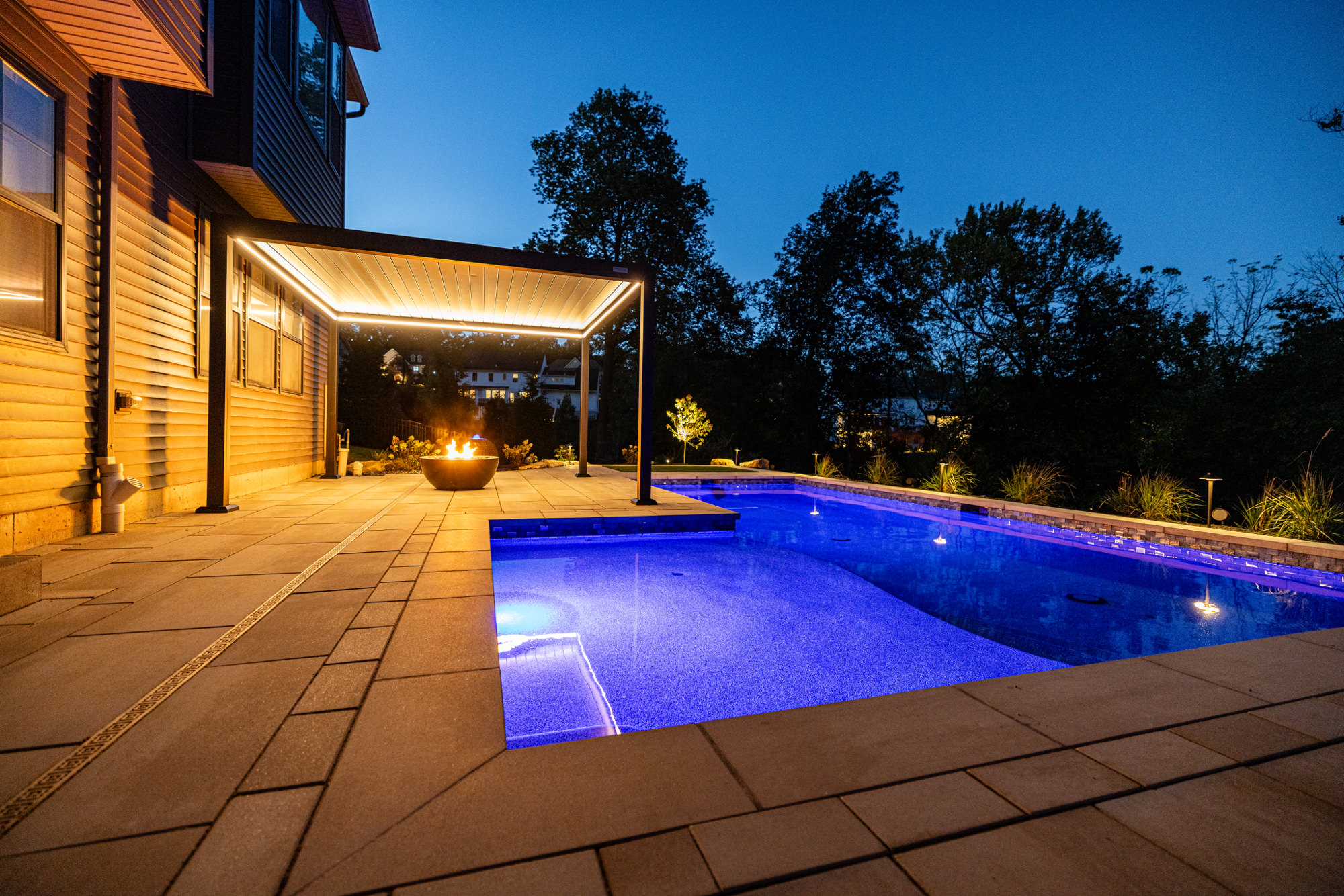 Modern poolside hardscape with large-format pavers in Coopersburg, PA
